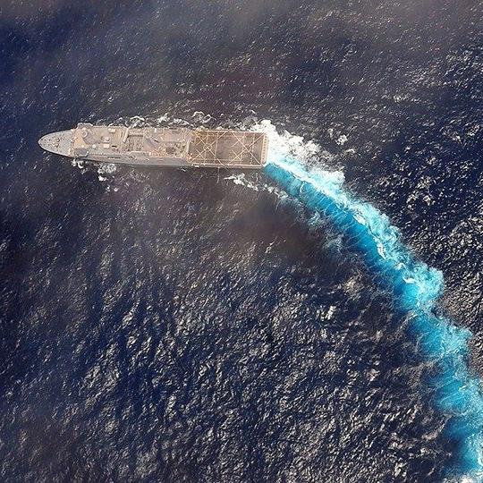 Aerial view of a military ship out at sea