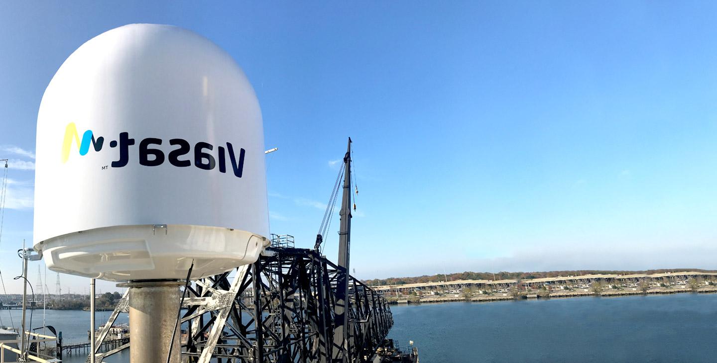 Maritime terminal radome with a vibrant Viasat logo installed on a vessel